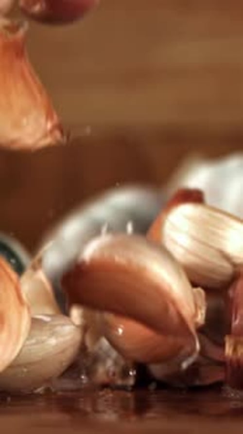 Garlic Falls on a Wooden Table Filmed on a Highspeed Camera at 1000 Fps