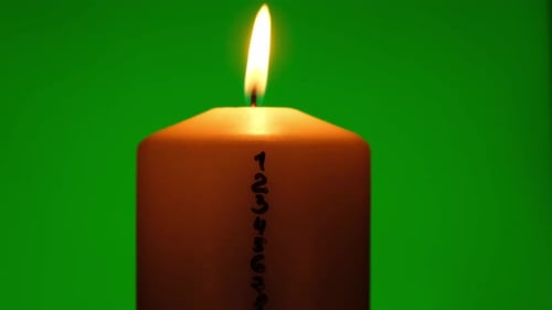 Candle with Advent Calendar on Green Chroma Key Background Traditional Burning Christmas Wax Candles