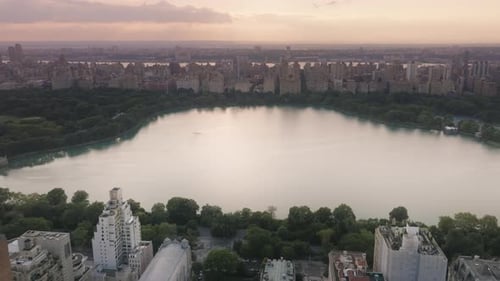 Beautiful Lake Surrounded By Green Park and Buildings Central Park Landscape US