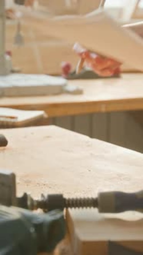 Vertical of Anonymous Girl Putting Paper Sketches on Table Covered in Sawdust