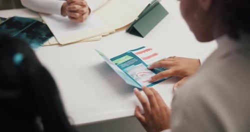 Dentist, brochure and patients in clinic for consultation on mouth hygiene procedure for oral care