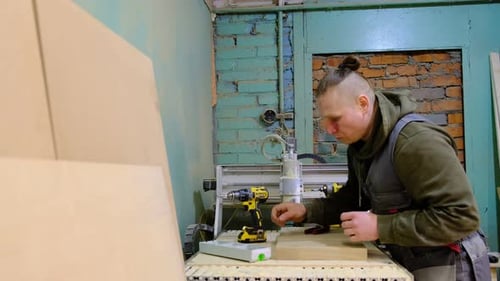 Close Up Carpenter Holding a Measure Tape on the Work Bench Woodwork and Furniture Making Concept