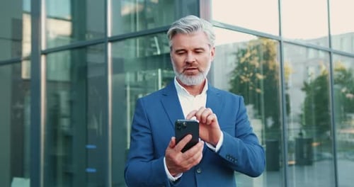 Excited Businessman Cheering at Good News on Phone