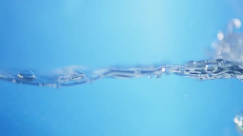 A drop of water falls into a calm pool, rippling out in perfect circles. A serene and peaceful refle