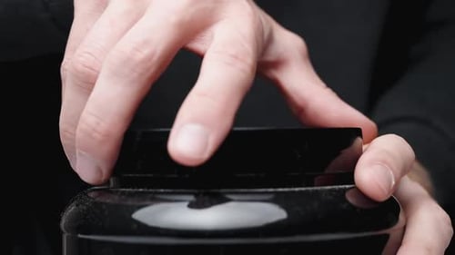 Unscrewing the lid of a large black sports nutrition jar, close-up.