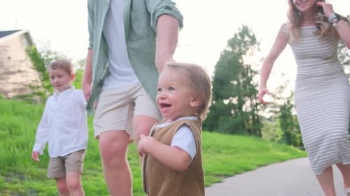 A Family Enjoys a Leisurely Walk in a Picturesque Park Together