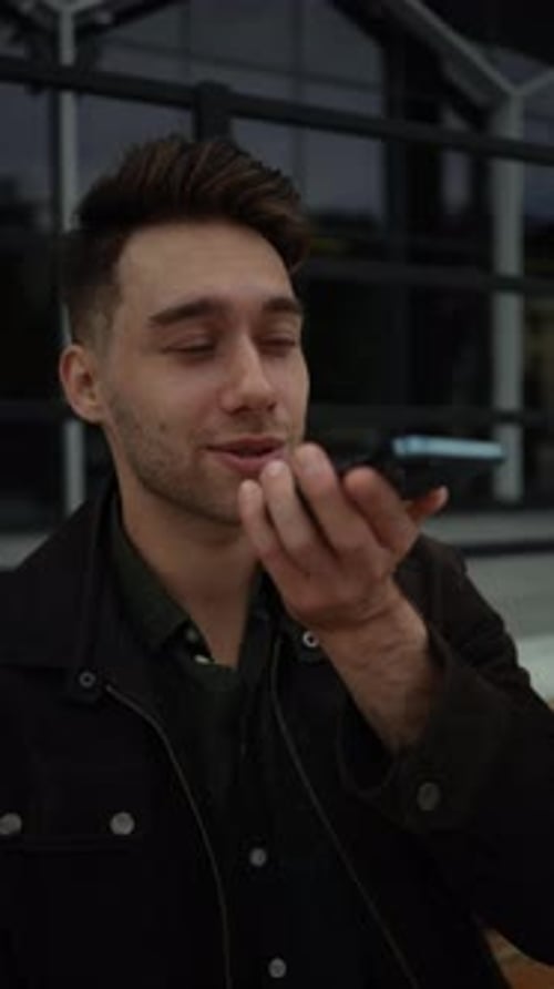Young Man Talking on Cellphone in Urban Setting