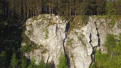 A Majestic Rock Formation That Is Beautifully Surrounded By Lush Greenery and Nature Stock Clip