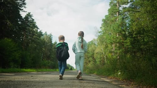 Back View of Children Walking on Forest Road