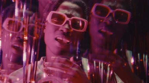 Kaleidoscopic Effect of Black Hip-Hop Performer Rapping to Camera in Neon Lights
