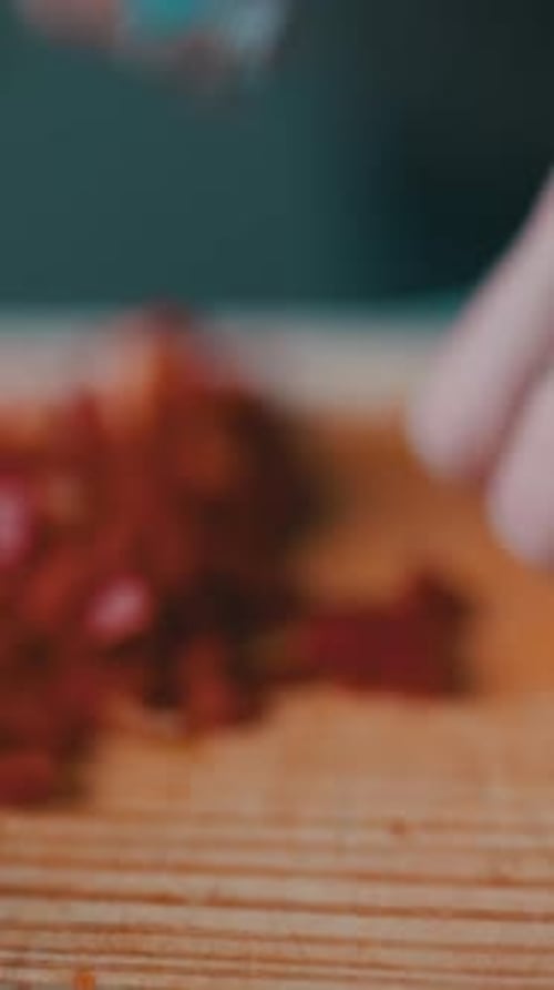 Close up of hands dicing red bell pepper
