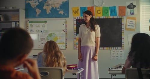 Female Teacher Calling Young Student to the Board Primary School Boy Showcasing Knowledge of Ecology