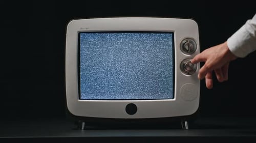 Vintage Television Screen with Hand Pressing Button