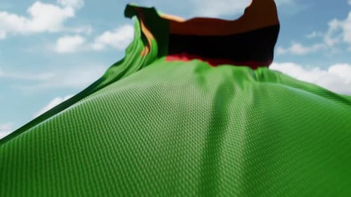 Realistic Zambia National Flag Waving against Blue Sky