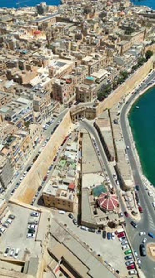 Aerial drone view of the walled city of Valletta, Malta, surrounded by the Mediterranean sea in dayl