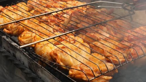 Delicious Chicken Frying on Barbecue Grill Grate Outdoor Seasoning Falling on Fresh Grilled Chicken