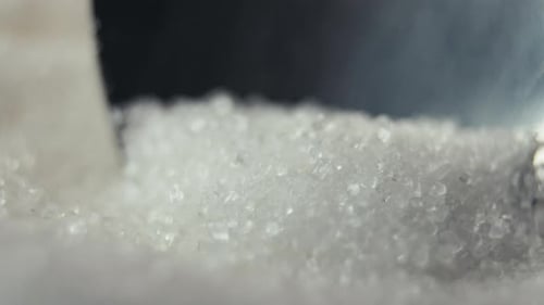 White Sugar Crystals in a Spoon Closeup Health Care and Diet Diabetes