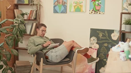 Man Using Tablet for Art and Design at Home