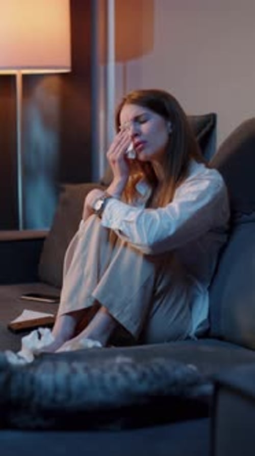 Woman Crying Alone Sitting on Sofa at Night