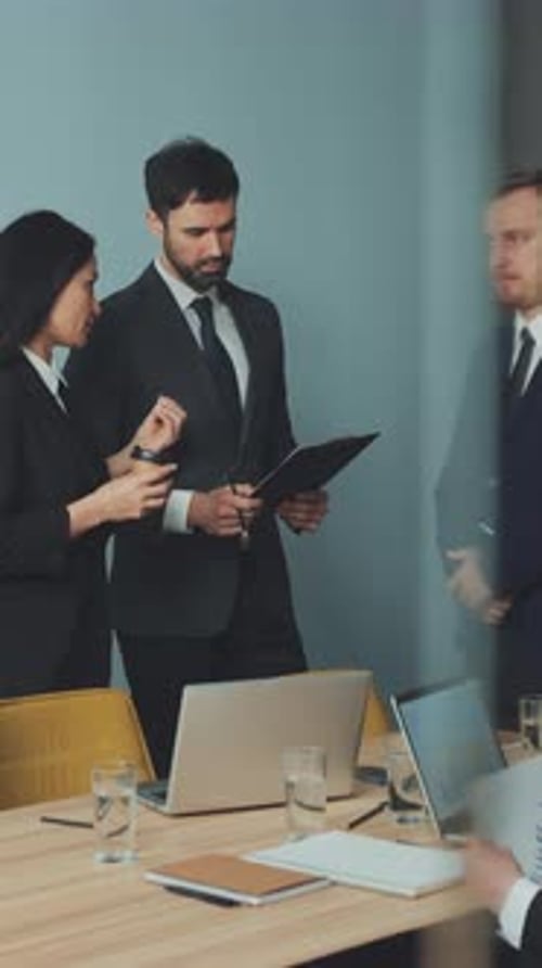 Business Professionals in a Modern Office Discussing Documents
