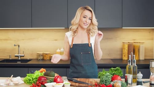 Woman Presenting Vegetables in Modern Kitchen