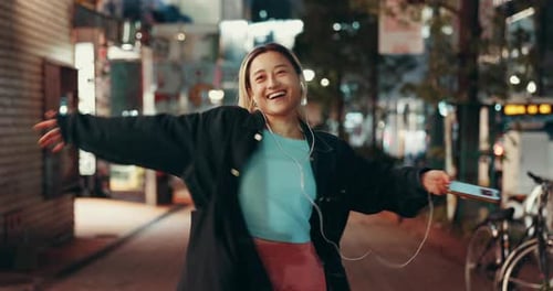 City, night and woman with phone for dancing, audio track and happy with music for kpop playlist