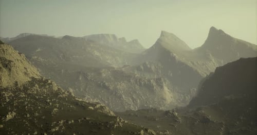 Majestic Mountain Range Bathed in Soft Sunlight During Early Morning Hours
