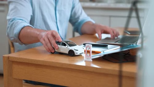 Un
designer automobile analyse soigneusement un prototype de voiture. Fastidieux