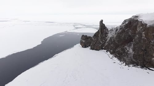 Aerial View of Floating Ice Floes in the Water Rocky Khoboy Cliff Lake Baikal