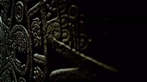 Dark Stone Carving with Fierce Face