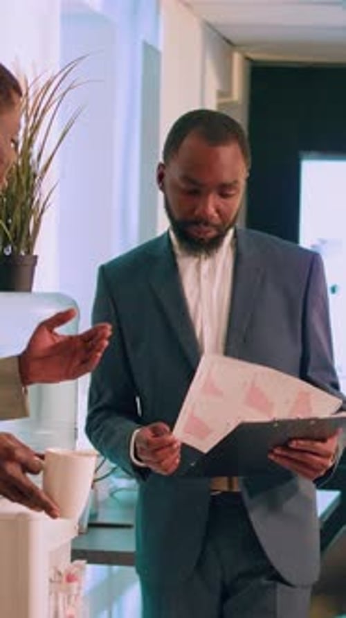 Vertical Video Business Manager Checking Up on Employee