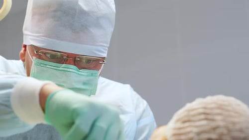 Concentrated Surgeon Performing Operation in Modern Medical Center Attentive and Focused Doctor