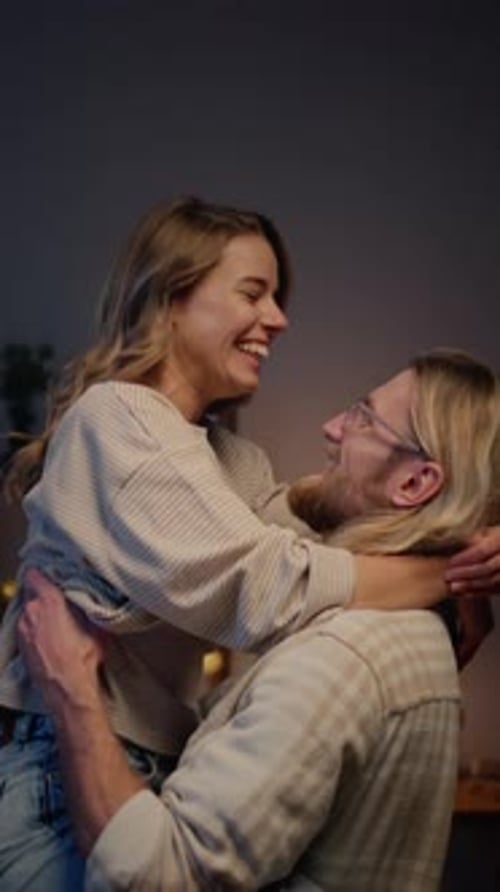 Affectionate Couple Embracing and Smiling in Cozy Setting