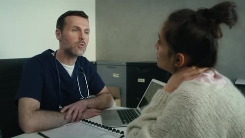 Doctor Discusses Medical Scan with Patient in Office