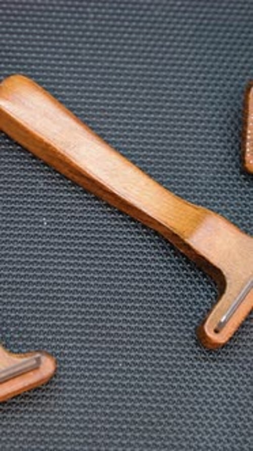 Wooden Grooming Tools for Pets on a Textured Surface