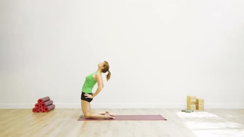 Woman Doing Yoga Kneeling Backbend on Yoga Mat