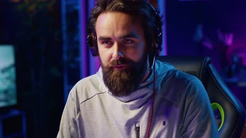 Man Wearing Headphones Talking to Microphone at Night