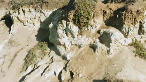 Flying in reverse over a rocky, desert landscape.