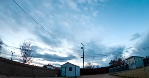 Clouds Drifting Across Blue Sky at Sunset