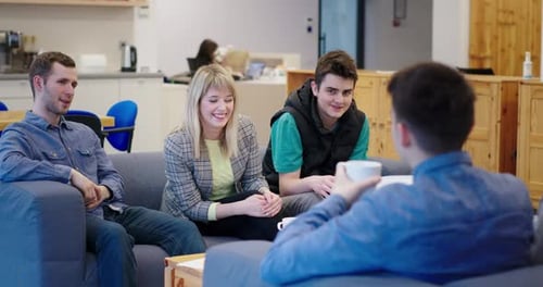 Team of Young People Working Together in the IT Company Sitting in the Office Recreation Area on