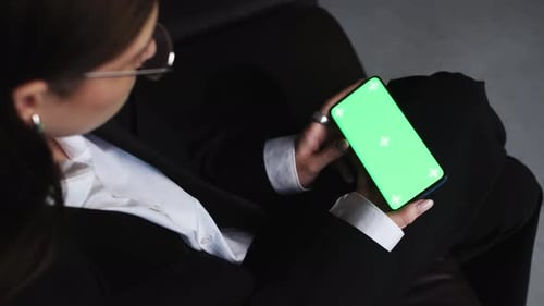 Woman Holds Phone with Green Screen