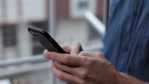 Adult Using Smartphone in Urban Setting
