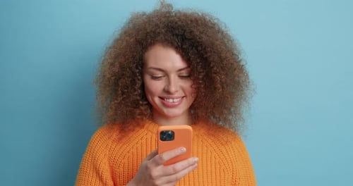 Smiling woman looking at a phone close up