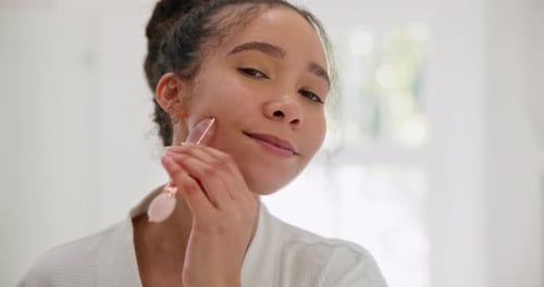 Face, skincare and woman with derma roller in bathroom for wellness, collagen