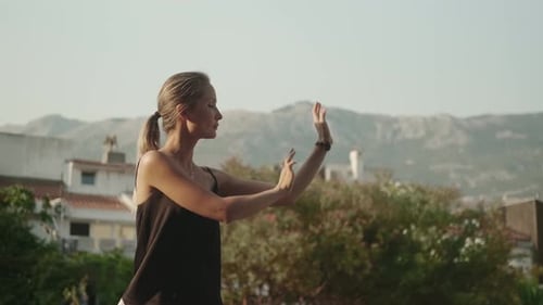 Woman Practices Serene Tai Chi Outdoors