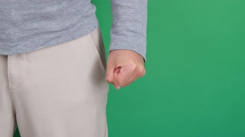 Adult's Fist Against Green Screen