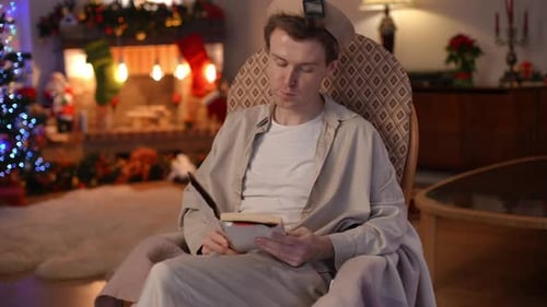 Relaxed Caucasian LGBT Man Reading Closing Book Thinking Looking Away