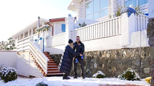 Parents with a baby boy on the walk on winter day.