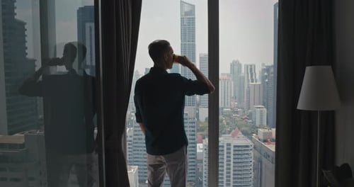 Urban Apartment Man Looking Through Panoramic Windows Modern Metropolis with Towering Skyscrapers