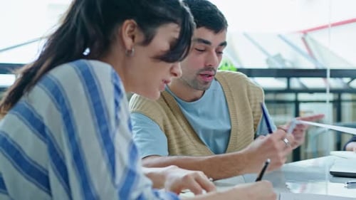 Young Coworkers Discussing Business Papers on Meeting in the Office